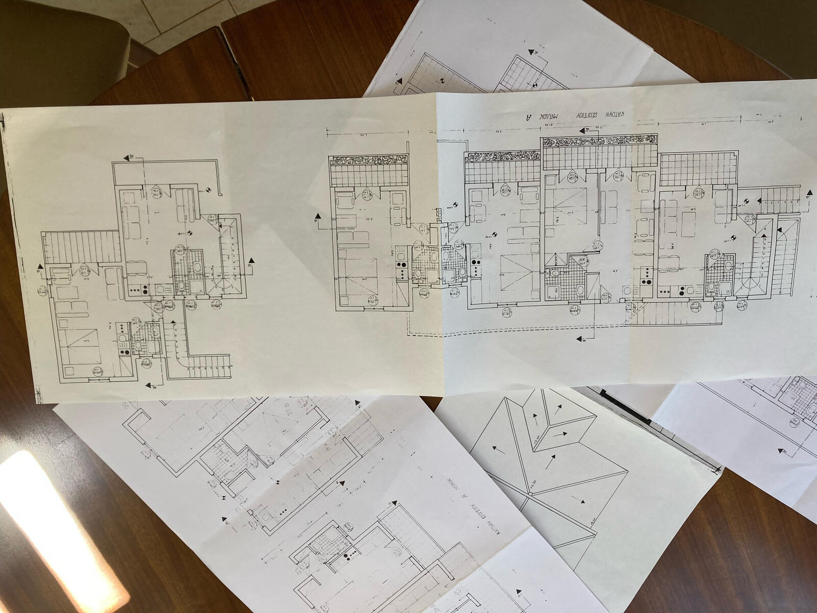 Complicated schematics of the base are laid out on a table.